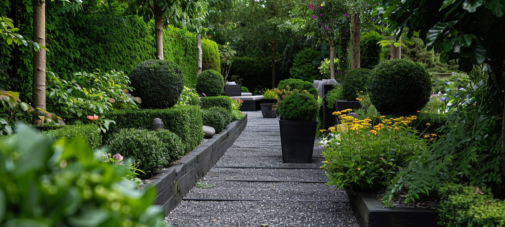 Pathway lined with trimmed trees and shrubs